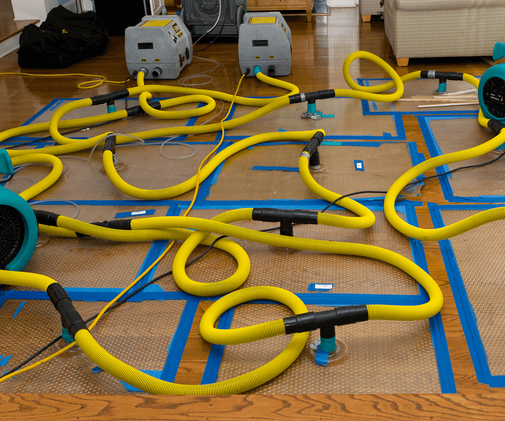 A complex yellow tube maze on a taped floor setup.