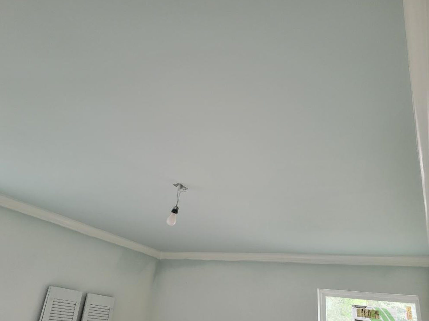 Minimalist white ceiling with a single light fixture.