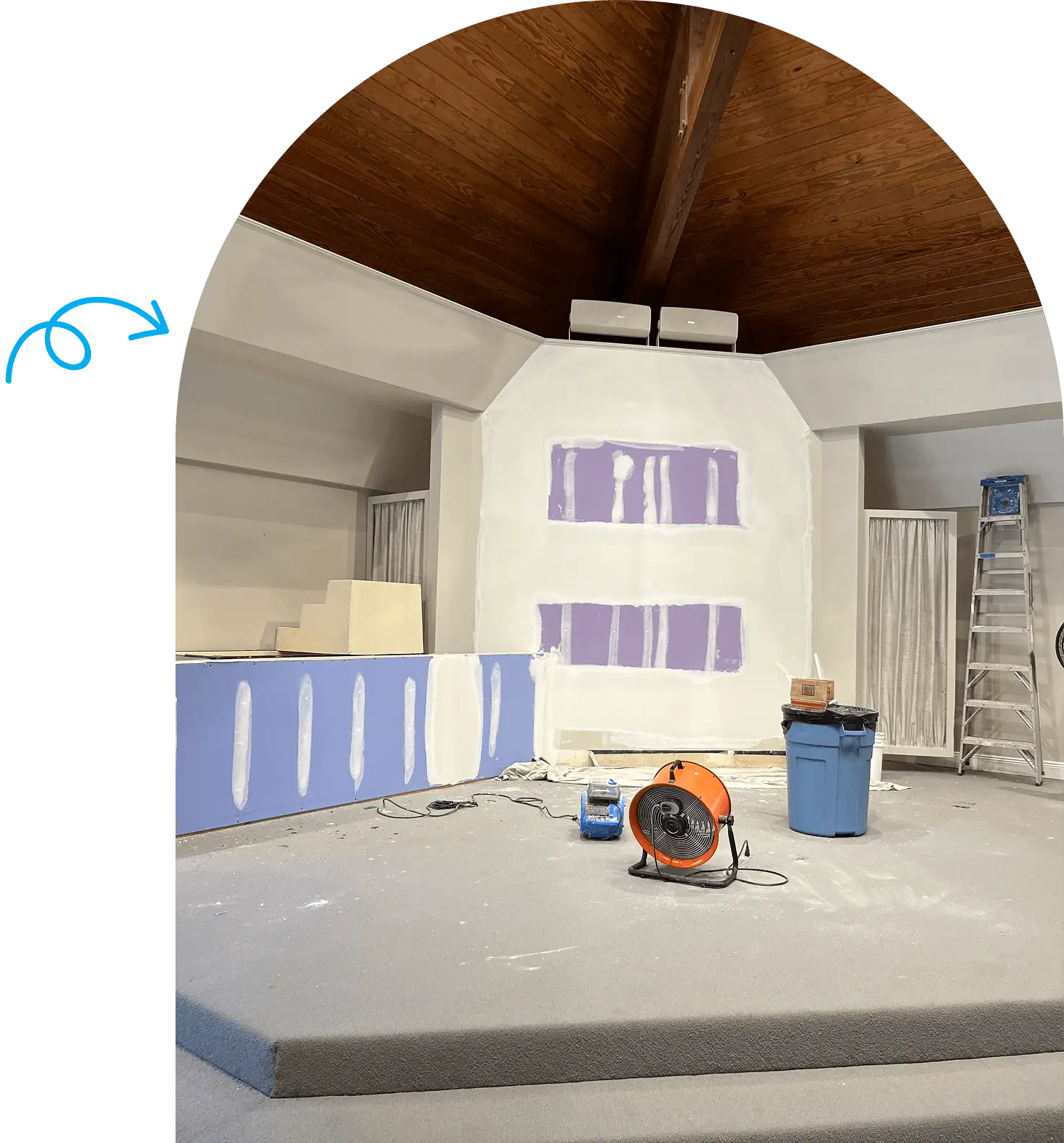 Church stage under renovation with construction tools.